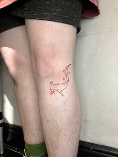 the legs of two people with tattoos on them