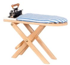 a small wooden table with a blue and white striped cloth on it's top