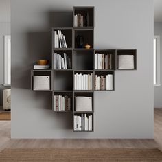 a bookshelf filled with lots of books on top of a hard wood floor