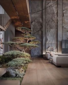 a living room filled with lots of furniture and trees on the wall next to it