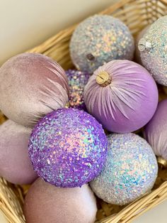 purple and blue ornaments are in a basket