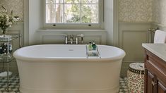 a white bath tub sitting next to a window