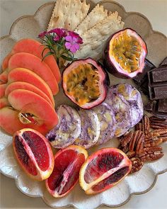 a plate filled with fruit and nuts on top of a table