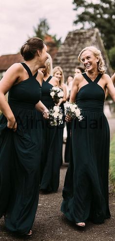 the bridesmaids are laughing together in their black dresses