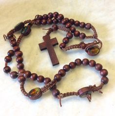 Lovely wood rosary. Wood beads, cross crucifix and rope knotted. Epoxy oval beads with two sided epoxy pictures. Holy family and crucifixion among others. Excellent condition. Measures 21 inches top to bottom. Great gift for vintage rosary collector. Thanks for looking. D7 Handmade Brown Crucifix Rosary, Brown Cross Rosary In Spiritual Style, Brown Cross-shaped Spiritual Rosary, Brown Spiritual Rosary With Cross, Brown Cross Shaped Spiritual Rosary, Holy Family Pictures, Red Spice, Types Of Red, Rope Knots