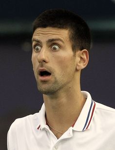 a male tennis player is making a surprised face