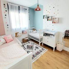 a baby's room is decorated in pastel colors