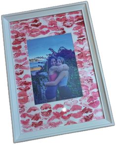 an image of two women hugging each other in a white frame with pink flowers on it