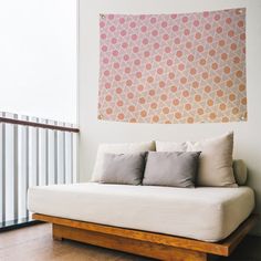 a white couch sitting in front of a window