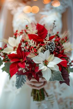 a bride holding a red and white bouquet with poinsettis