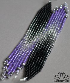 purple and black seed bead necklace with silver beads on grey background, closeup