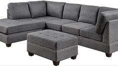 a gray sectional couch with ottoman and footstool