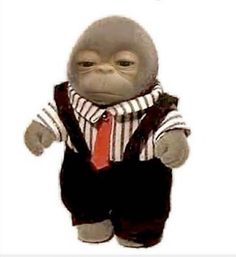 a stuffed monkey wearing a suit and tie with the caption, i don't know what this is