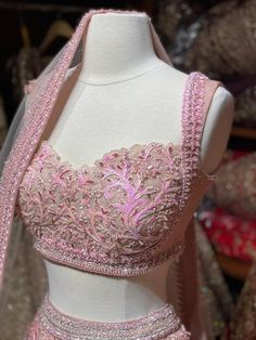 Lemonade pink intricate with fully sequence thread embroidery and crystal stone work lehenga paired with sweetheart neckline blouse and net dupatta. Pink Shimmery Lehengas Which Are To Die For! Fabric:Net Size:38 Ready to Ship! White Stone Blouse Designs, Sweetheart Neckline Lehenga, Sweetheart Neckline Blouse Lehenga, Beaded Lehenga Blouse, Pink Party Wear Blouse Piece For Wedding, Bollywood Style Embellished Pink Embroidered Fabric, Pink Embellished Sharara For Wedding, Semi-stitched Georgette Lehenga With Handwork, Wedding Lehenga In Georgette With Handwork