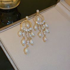 ✦ Elevate your elegance with our classy chandelier earrings, showcasing a timeless freshwater pearl design that exudes sophistication. Crafted for those special moments, these earrings are the epitome of refinement, making them an ideal choice for weddings and engagements. The chandelier style adds a touch of grandeur, ensuring you shine on your special day. The lustrous freshwater pearls create a classic and enduring accessory that complements bridal ensembles with grace. Let these earrings be