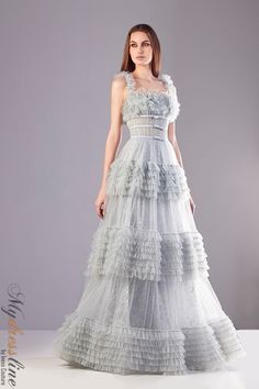 Looking for a show-stopping dress for your next big event? Check out the Sara Badr 27015 Spring 2021 evening collection dress. Whether you're attending a gala, wedding, or another formal event, this dress is sure to turn heads. Elegant Tulle Ball Gown With Lace Bodice, Elegant Lace Ball Gown With Sheer Bodice, Elegant A-line Tulle Gown, Elegant Evening Dress With Lace Bodice And Organza, Elegant Lace Ball Gown For Gala, Elegant Tulle Ball Gown With Ruffles, Elegant Tulle Wedding Dress With Ruffles, Wedding Gown With Fitted Bodice And Square Neck, Plastic Dress