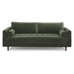 a green couch sitting on top of a white floor