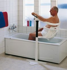 a man sitting in a bathtub with no shirt on