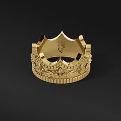 a gold crown ring with fleur-de-lis designs