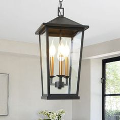 a dining room table with two chairs and a light fixture