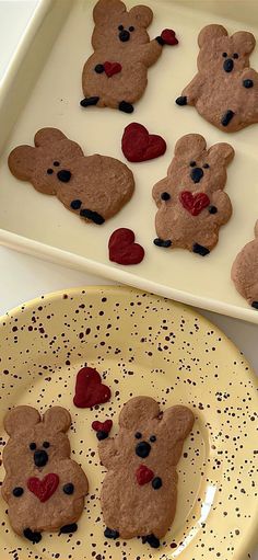 some cookies shaped like teddy bears on a plate with hearts in the shape of them