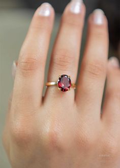 Our Garnet Gemstone Ring features a deep red faceted oval garnet set in a classic four prong setting. This January birthstone ring is Handmade in 925 silver base with a thick coating of nickel free 18k Gold Vermeil. D E T A I L S Stone size - Large - 10mm x 8mm Band size - 2mm Material: 18k thick gold vermeil over 925 sterling silver, genuine red Garnet gemstone Birthstone Month: January S H I P P I N G * Processing time - 2 business days, usually ships the next day. We are closed on Saturdays a Silver Rings With Red Stone, Birthstone Gold Ring, Gold Ring With Ruby Stone, January Birth Stone Rings, Gold And Garnet Ring, Oval Garnet Ring, Gold Stone Rings For Women, Ruby Gemstone Ring, Garnet Silver Ring