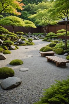 a japanese garden with rocks, grass and benches