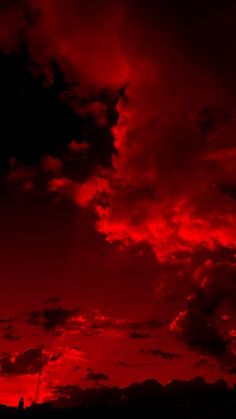 the sky is red and cloudy at night