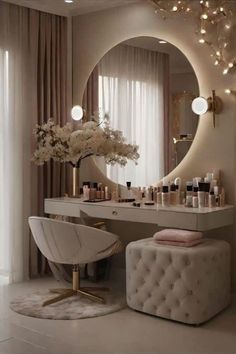 a white chair sitting in front of a vanity with lights on the wall and a mirror above it