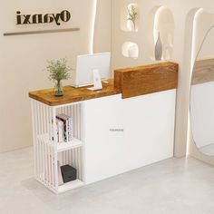 a desk with a computer on it in front of a mirror and wall mounted shelves