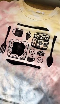 a t - shirt with an image of food and utensils drawn on it