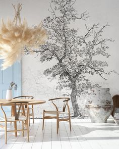 a room with a tree painted on the wall next to chairs and tables in front of it