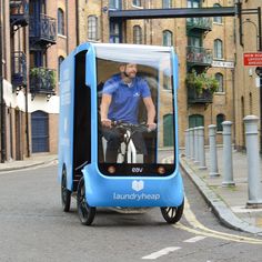 a man riding on the back of a blue cart