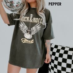 Edgy, glam boho guitar wings rock & roll soul tee. Add a retro vibe to your Comfort Colors® t shirt collection! Graphic is distressed for an instant vintage vibe. Size up for an oversized look (see size chart in listing photos). Makes a great gift, too! Looking for more graphic chic apparel? Check these out: https://www.etsy.com/shop/TheGraphicPeach?ref=seller-platform-mcnav§ion_id=30193152 For environmental and human friendly reason, this product is only made when you order it using direct to garment print technology. Turnaround time is 3-10 business days before shipping. Our professional printers always strive to ship as quickly as possible, but faster times are not guaranteed. SIZING This is a standard unisex sized Comfort Colors Tee. FOR AN OVERSIZED FIT, please size up. If you are loo Rock And Roll T-shirt For Summer Concerts, Summer Rock And Roll T-shirt For Concert, Rock And Roll Graphic Print Tops For Spring, Rock And Roll Summer T-shirt With Relaxed Fit, Rock Style Graphic T-shirt For Spring, Rock And Roll Graphic Print Spring Tops, Rock Style Graphic Print T-shirt For Summer, Rock Style Graphic Print T-shirt For Spring, Rock Style T-shirt For Summer Concerts