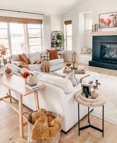 a living room filled with furniture and a fire place in the middle of a room