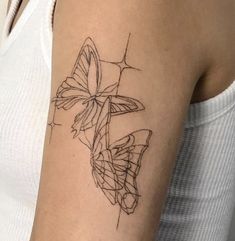 a woman's arm with a butterfly tattoo on the left side of her arm