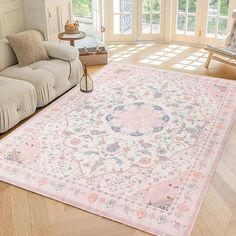 a living room filled with furniture and a large rug on the floor in front of a couch