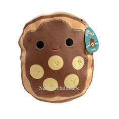 a brown stuffed animal with buttons on it's face