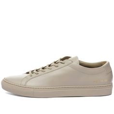 Presented In A Neutral Colourway, These Smooth Original Achilles Low Sneakers From Common Projects Are Sure To Complete Any Outfit With A Touch Of Minimalistic Cool. Built With All-Leather Uppers, The Simplistic Shoes Are Completed With A Base Of Tonal Rubber. * Leather Uppers * Leather Lining * Gold Foil Style Code * Rubber Outsole * Made In Italy Classic Beige Sneakers With Rubber Sole, Classic Beige Sneakers With Stitched Sole, Casual Beige Calf Leather Sneakers, Beige Sneakers With Rubber Sole And Plain Toe, Classic Cream Sneakers With Leather Sole, Beige Sneakers With Rubber Sole, Beige Plain Toe Sneakers With Rubber Sole, Classic Beige Sneakers With Textured Sole, Beige Plain Toe Sneakers With Leather Sole