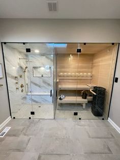 a bathroom with a walk in shower next to a tiled floor and walls that have been built into the wall