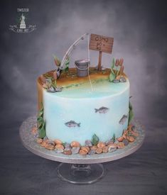 there is a cake that has been decorated with fish and fishing gear on it,