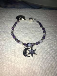 This bracelet is a Moon and Star Bracelet with purple beads, crystals, and silver accents, magnetic clasp with charm. I make all jewlery to order to let the customer customize color, size, and even charms. I appreciate your support! Thank you! Love and Light! If you require any special adjustments please message me. Standard bracelets are 7.5 inches. Purple Adjustable Celestial Jewelry, Adjustable Purple Celestial Jewelry, Handmade Purple Sterling Silver Beaded Bracelets, Spiritual Nickel-free Purple Beaded Bracelets, Spiritual Purple Crystal Bracelet With Spacer Beads, Spiritual Purple Beaded Charm Bracelet, Purple Star-shaped Beaded Jewelry, Afro Jewelry, Grunge Jewelry