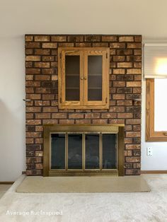 an empty living room with a fireplace and cabinets