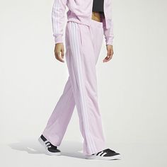 Comfort and style unite with these women's velour 3-stripe tracksuit pants. Designed with a wide leg at the bottom hem and snaps, wear the pant open or tapered based on your style. Featuring three-stripes at the side leg and an elevated gem branding at the wearers left leg, this pant mixes with your favorite pieces and features primegreen trims, echoing our commitment to sustainability.Front Style: Flat FrontClosure Type: DrawstringFit: Regular FitPockets: 2 Front Zip PocketsRise: Mid RiseSupport: Light SupportFiber Content: 100% Recycled PolyesterFabric Description: VelourInseam: 29 1/2 InLeg Style: Straight LegCare: Tumble Dry, Machine WashCountry of Origin: Imported Adidas Sporty Wide Leg Sweatpants, Adidas Sporty Wide Leg Pants, Adidas Sporty Wide-leg Pants, Adidas Three Stripes Pants, Adidas Sporty Wide Leg Bottoms, Adidas Sporty Wide-leg Bottoms, Full Length Pants With Side Stripes, Sporty Wide Leg Pants For Spring, Adidas Wide Leg Casual Sweatpants