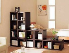 a living room filled with furniture and bookshelves on top of eachother