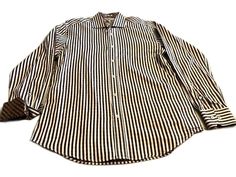 This is a mint condition Bugatchi Men's casual button-down shirt. It has the Bugatchi logo embroidered on the sleeves, the placket, and inside the back yoke. It has great square mother-of-pearl buttons. The cuffs are double button & roll to a contrasting pattern as seen in the last photo. The stripe / checked pattern is in navy, brown & sliver gray making it great to pair with jeans or dress pants. It is a size Medium. Bugatchi is renowned for attention to detail and making quality shirts & they are made in the USA. Classic Striped Shirt For Fall, Casual Long Sleeve Dress Shirt With Striped Collar, Button Ups, Mens Fall, Mens Oxfords, Mother Of Pearl Buttons, Pearl Buttons, Casual Shirt, Men's Casual