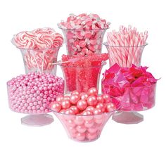 there are many pink and white candies in the vases