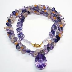 "DESCRIPTION: Thank you for coming in! A breath-takingly beautiful necklace made of an assortment of natural gemstones! You can find Iolite, Amethyst, sunstone and peach moonstone in this one necklace! Premium quality gemstones finished with gold filled headpins and 18k solid yellow gold clasp! 17\" gorgeous necklace, 186.9 carats! You'll get the necklace you see! SIZE: 14.7mmx23.5mm center stone. GRADE: Transparent COLOR: Multi" Amethyst Briolette Necklace With Gemstone Accents, Luxury Amethyst Multi-stone Necklace, Luxury Multi-stone Amethyst Necklace, Briolette Amethyst Natural Stone Gemstones, Luxury Amethyst Gemstones With Natural Stones, Luxury Natural Amethyst Gemstones, Teardrop Amethyst Necklaces With Gemstone Accents, Luxury Amethyst Necklaces With Natural Stones, Natural Teardrop Amethyst Gemstones