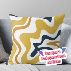 a yellow and blue pillow with the words support independent artists in pink lettering on it