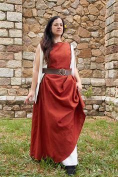 Sleeveless dress. Elegant and simple, she designed this historical medieval dress to show off her natural beauty and enhance her body with a belt. Used in larp clothing, sca, Renaissance Faires and more. With simple embellishments on the neckline and armholes, giving priority to the shape of the dress. Inspired by the twelfth century, where the clothing consisted of wearing a chemise and a dress open on the sides to the hip. It will be girded by a belt at the waist. The upper dress was shorter than the inner one. The chemise hugged the body while the dress gave volume to the hips.   The neckline of this medieval dress is round. It is not a tight dress, in the early years of the Middle Ages, both men and women wore this loose garment. The beauty of this dress is in the flight of the skirt j Larp Clothing, Medieval Reenactment, Dress Woman, Medieval Dress, Dress Elegant, Early Years, Linen Clothes, Middle Ages, Larp